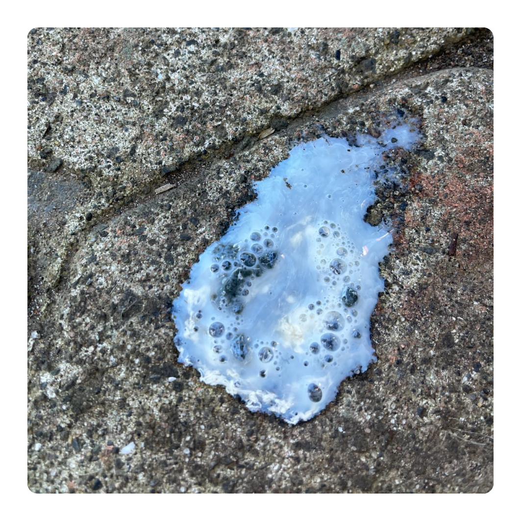 Blue foam dropping on a concrete surface