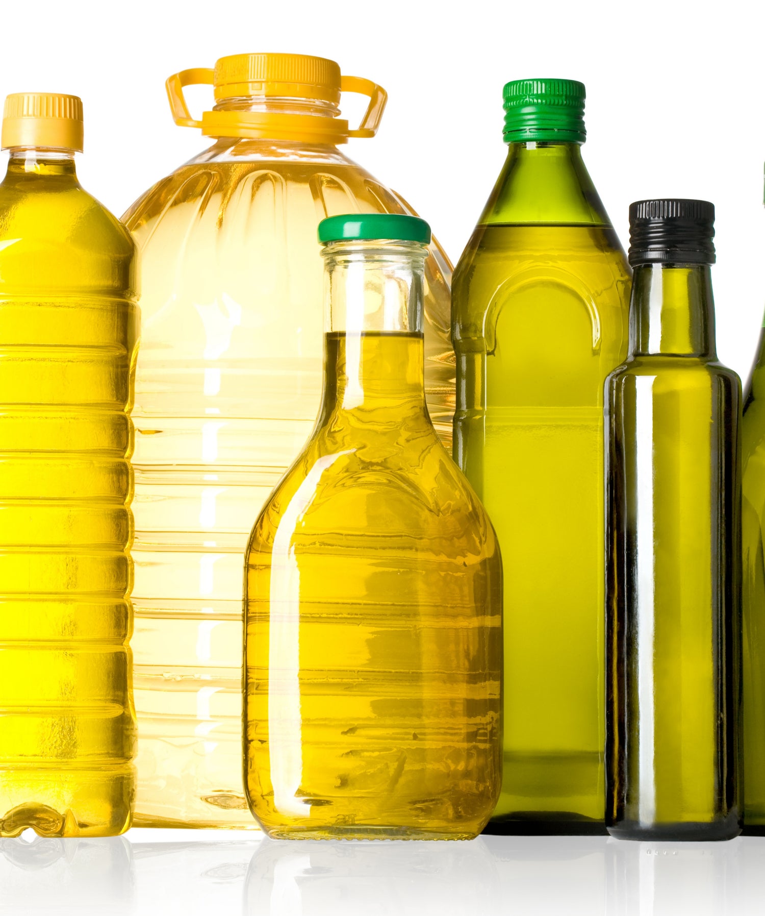 Collection of oil bottles with various sizes and colors on a white background